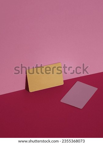 Metallic and golden business cards on pink background with shadow. Creative layout, minimalism