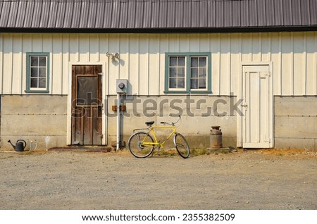 Vintage Yellow Bicycle in front of Farm Building