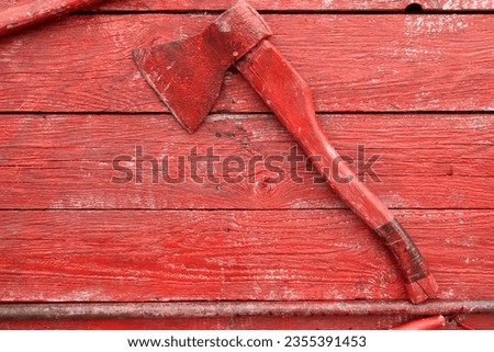 Fire shield with equipment on a wooden wall. Ax close-up.Ax close-up.