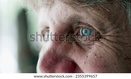 Happy senior man smiling, close-up macro detail of elderly person with wrinkles and blue eyes, expressing old age and wisdom while smiling Royalty-Free Stock Photo #2355399657