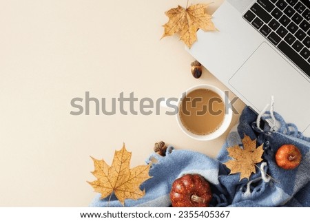 Craft a workspace that carries the comforting vibes of autumn. Top view photo of cozy blanket, laptop, hot cocoa, acorns, pumpkins, dry autumn leaves on pastel beige background with ad space