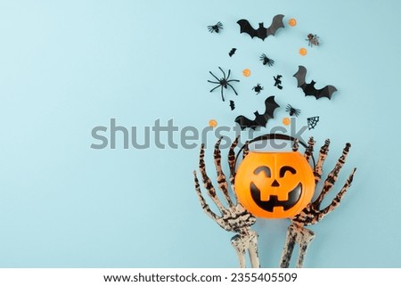 Partaking in the age-old rituals and customs of Halloween. Top view photo pumpkin basket, skeleton hands, spooky decor on light blue background with promo spot