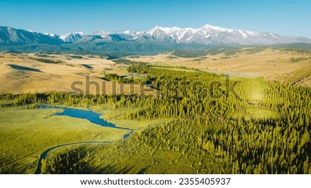 Early morning just after sunrise. Fog in the valley of the Chuya River. Coniferous forest in the fog. Kurai steppe. Summer landscape in Altai mountains, Siberia, Russia.