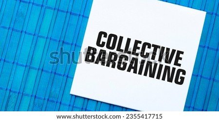 blank note pad with COLLECTIVE BARGAINING text on blue wooden background