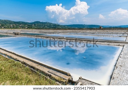 A view of reflections in the crystallisation pools at the salt pans at Secovlje, near to Piran, Slovenia in summertime Royalty-Free Stock Photo #2355417903