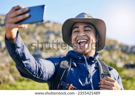 Selfie, freedom and a man hiking in the mountains for travel, adventure or exploration in summer. Nature, smile and photography with a happy young hiker taking a profile picture outdoor in the sun