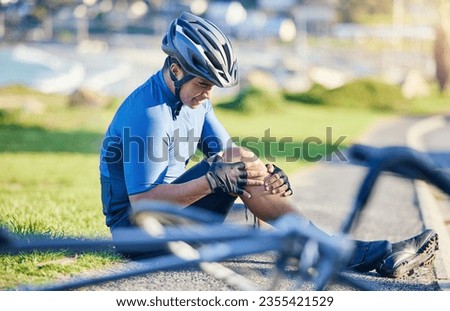 Man, outdoor and biker with knee pain, road and emergency with accident, health issue and fitness. Person, cyclist and athlete with broken leg, inflammation and bruise with medical problem and injury