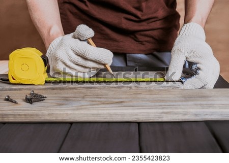 Banner of Carpenter Measuring a Wooden Plank by ruler in wooden workshop, carpenter measuring wooden timber or plank