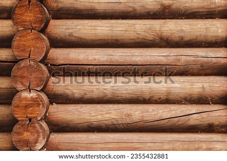 Closeup of the log wall construction with a swedish cope log profile. Dirty and heavily cracked wall of a blockhouse as a natural rural background Royalty-Free Stock Photo #2355432881