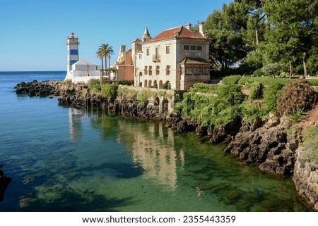 View of Santa Marta lighthouse and historical house, Cascais, Portugal Royalty-Free Stock Photo #2355443359