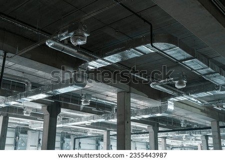 Air ventilation system on the ceiling in a large warehouse Royalty-Free Stock Photo #2355443987