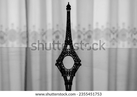 Backlit silhouette of a miniature Eiffel Tower
