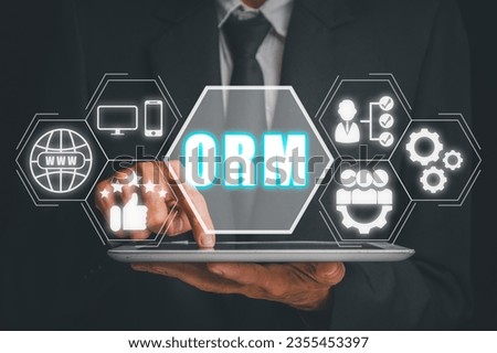 ORM, Online Reputation Management Optimization Business concept, Businessman using tablet with Online Reputation Management icon on virtual screen. Royalty-Free Stock Photo #2355453397