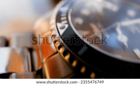 Close up photo of a gray stainless steel watch with color lights