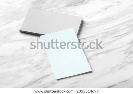 Pastel blue and grey business card mockup on white marble background