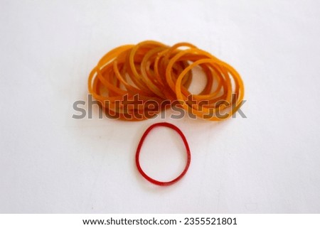 gold colored rubber bands and 1 red color