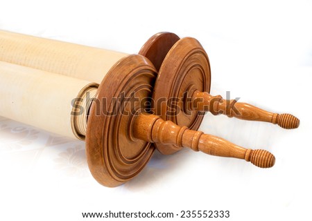  The Hebrew handwritten Torah, on a synagogue alter, illustrating Jewish holidays, during fests. Closed version with wooden handles.  Royalty-Free Stock Photo #235552333