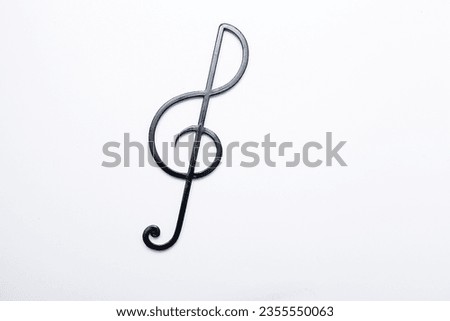 Three cut-out colorful paper butterflies and a musical treble clef. Royalty-Free Stock Photo #2355550063