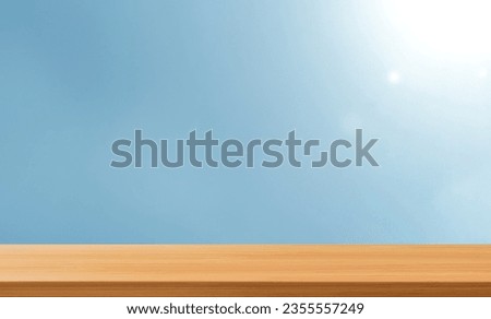Beautiful Empty wood Table with len flare blue background