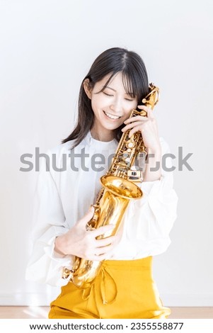 Japanese woman with saxophone at home