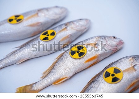 Radioactively contaminated fish. nuclear electric power waste water container radioactive to fish.  Japan starts discharging treated water into the sea. Japan nuclear power plant into the ocean.  Royalty-Free Stock Photo #2355563745