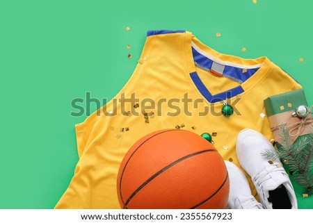 Basketball uniform with Christmas decor and gift on green background