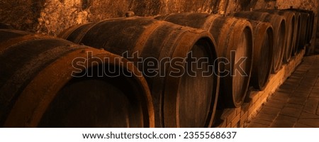 Many wooden barrels in cellar, banner design