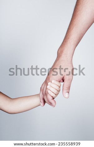 Child holds the hand of father Royalty-Free Stock Photo #235558939