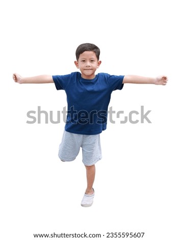 Asian little boy standing on one leg for balance and arms outstretched or keeping arms raised isolated on white background. Image with Clipping path.