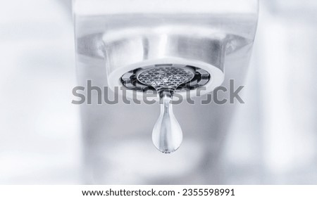 dripping water from a tap. lack or leakage of water Royalty-Free Stock Photo #2355598991