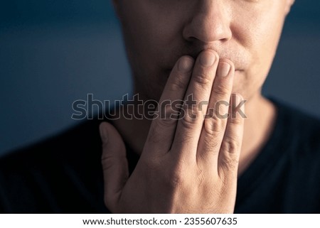 Oops, secret gossip. Lips sealed, mute. Surprise, shock. Quiet shy man cover mouth with hand. Censorship, freedom of speech or taboo concept. Secrecy or mistake gesture. No talking expression.  Royalty-Free Stock Photo #2355607635
