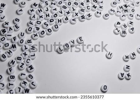 close up alphabet beads with the word love Royalty-Free Stock Photo #2355610377