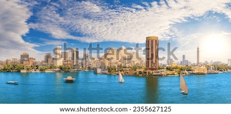 View on the Nile, Cairo city and famous Pyramids in the beautiful panorama of Egypt Royalty-Free Stock Photo #2355627125