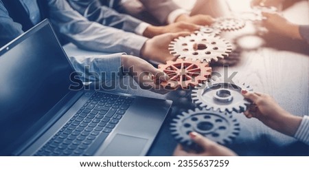 People joining cog wheel on the black desk. Royalty-Free Stock Photo #2355637259