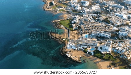 Drone shooting panorama of the coastline of the city with luxury hotels, villas, bays, ports with stylish yachts, sandy and rocky beaches and calm sea with clear blue water in Larnaca Cyprus. Royalty-Free Stock Photo #2355638727