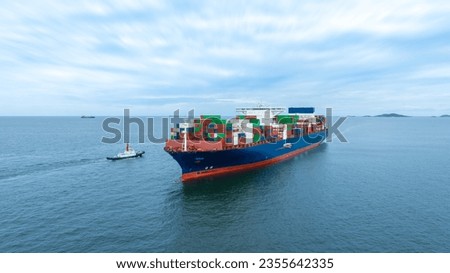 Aerial side view of cargo container ship carrying container from custom container depot go to ocean concept freight shipping by ship service on blue sky .Freight Forwarding Service