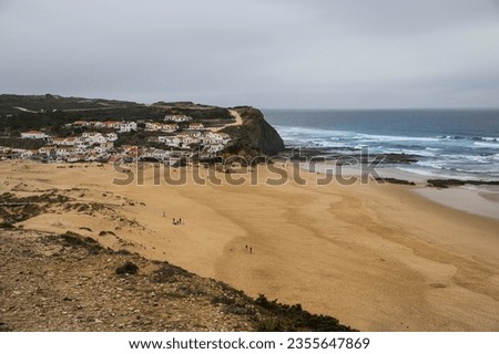 Beautiful Monte Clerigo Beach and Aljezur town in the background on a cloudy day
