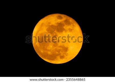 The yellow full moon (super moon) on black background for night and dark design concept. High Quality of full moon photo.

