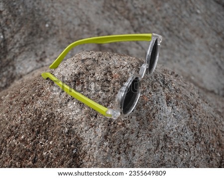 Black and green frame eyeglass on hill.Blur background with iconic image.It is using for optical clinic and advertisement also.