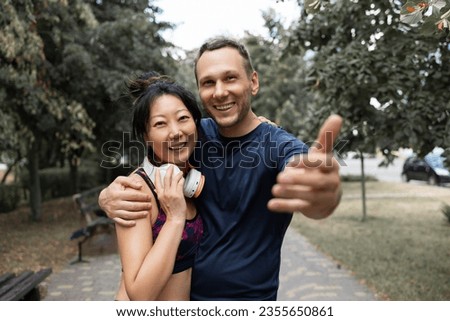 Joyful Sporty young Couple Taking Selfie On Smartphone After Training In Park, Posing For Photo On Path Outdoors. 