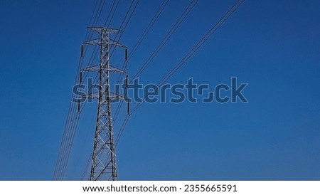 the pylon outline, Very High Voltage Power Lines (Indonesia : SUTET) on blue sky Royalty-Free Stock Photo #2355665591