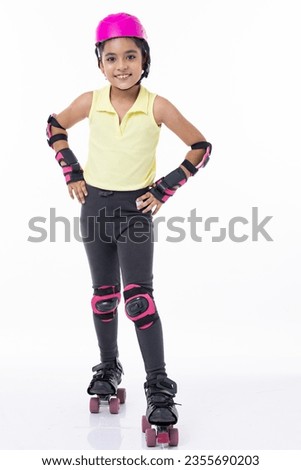 Full length portrait a happy girl on rollers isolated on white background