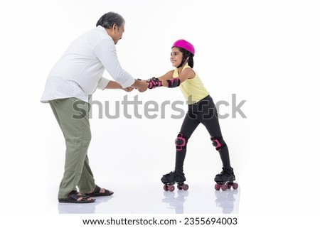 Father helping little daughter skating on roller skating  isolated on white background.