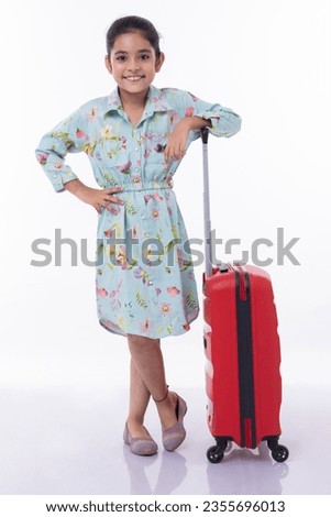 Little girl traveler with a suitcase on a white background