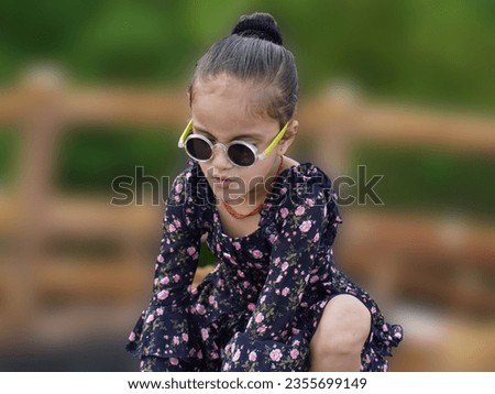 AI photo best example of filter effect to image.Technology macro pixelated picture of little girl with smiling face in eyeglass.Motion blur and redial blur effect on oil paint photo.
