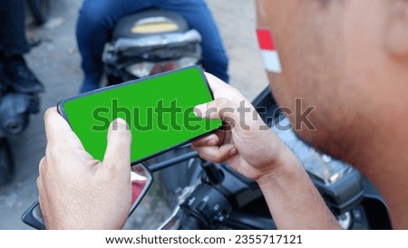 someone uses a phone with an Indonesian flag. green screen phone. this photo can use for mockup , banner, etc