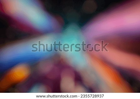 Background Colorful bokeh captured by a computer screen and lights. Blur the image mostly in red, blue, yellow and black.