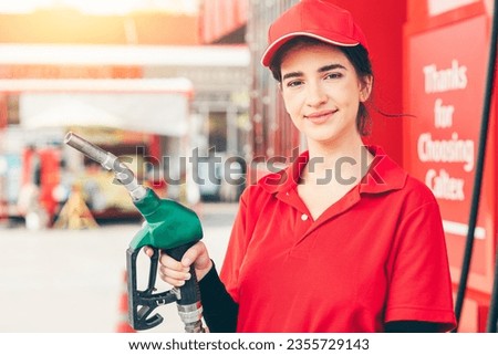 Gas station service staff worker women happy smiling with fuel nozzle for car gasoline refill job Royalty-Free Stock Photo #2355729143