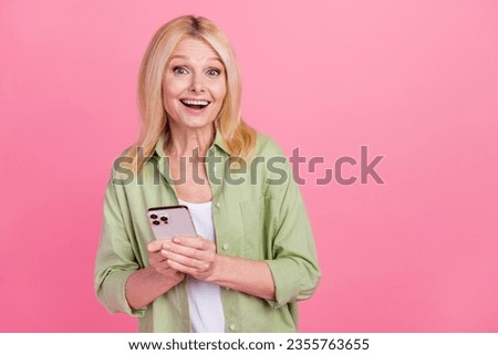 Photo of charming cheerful senior lady wear trendy khaki clothes rejoice sale discount empty space isolated on pink color background