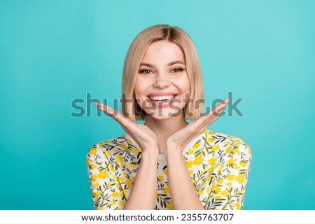 Photo of positive woman with bob hairstyle dressed flower print t-shirt talms demonstrate toothy smile isolated on teal color background